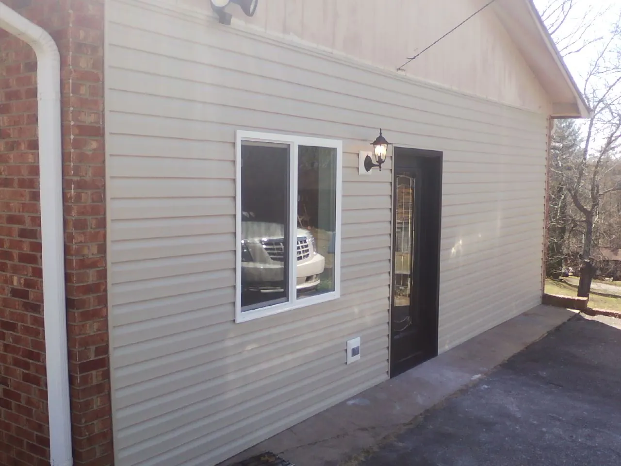 New vinyl siding and entry door on a room addition in Silsbee
