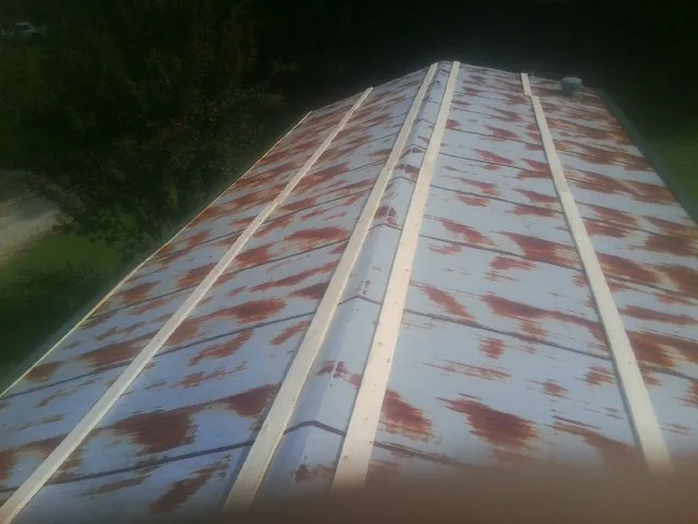 Rusted metal roof panels with new wood purlins before replacement — Storm Damage Roof Repair in Silsbee by Roofing Brothers